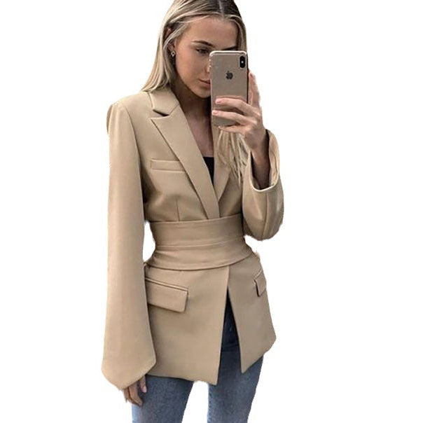 Women's autumn blazer with a belt and long bell sleeves.