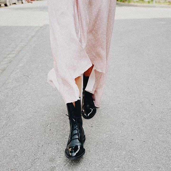 Women's mid-calf lace-up boots with a flat sole and British-inspired design.