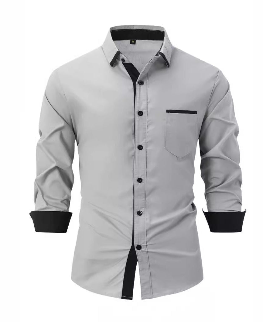 Camicia uomo grigia elegante, maniche lunghe, colletto classico, dettagli neri su polsini e bottoni, taschino frontale. Moda maschile formale.