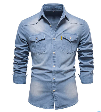 Men's solid-color denim shirt with textured fabric, chest pockets, and long sleeves.