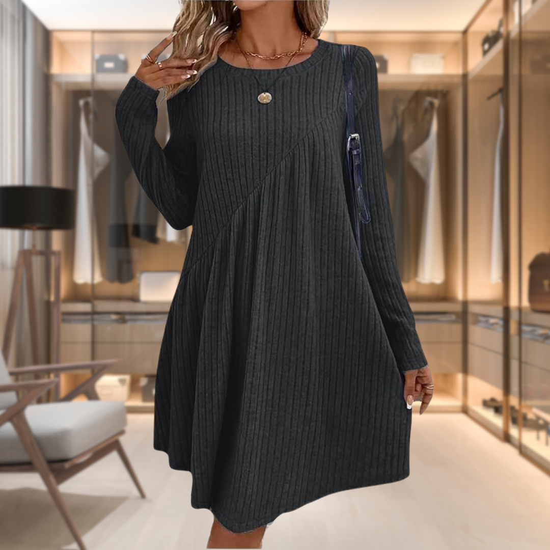Abito nero a coste, maniche lunghe, in una cabina armadio moderna. Moda donna elegante, stile casual chic, abbigliamento autunnale.