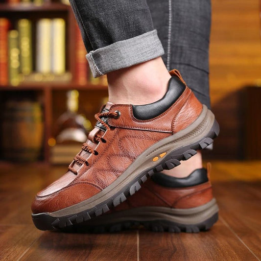 Men's hiking boots with laces, rubber soles, and a rugged design.