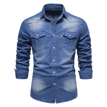Men's solid-color denim shirt with textured fabric, chest pockets, and long sleeves.