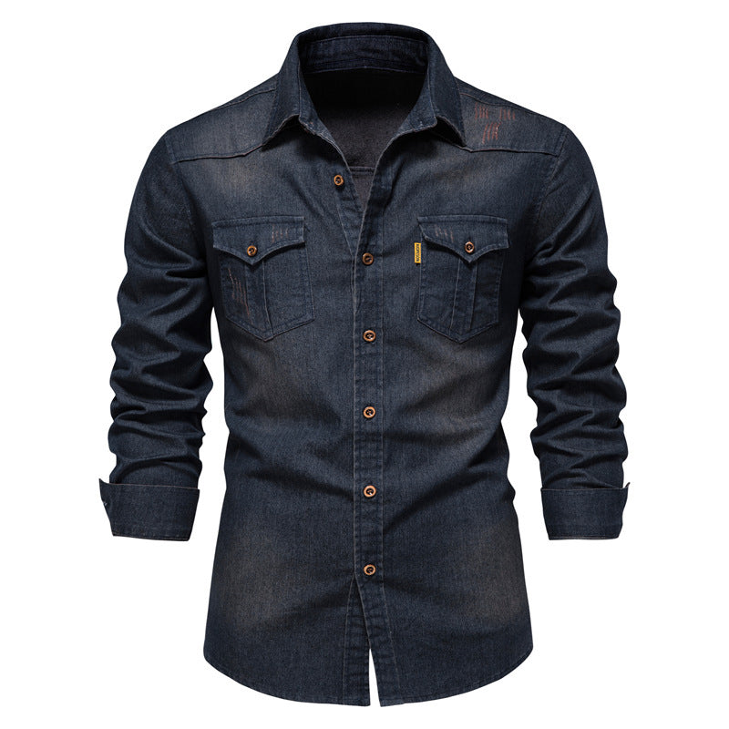 Men's solid-color denim shirt with textured fabric, chest pockets, and long sleeves.