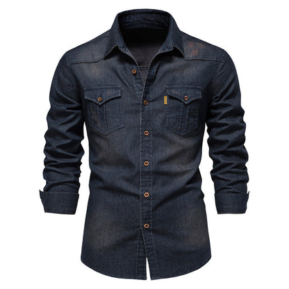 Men's solid-color denim shirt with textured fabric, chest pockets, and long sleeves.