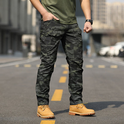 Uomo in pantaloni mimetici e stivali gialli su strada urbana. Moda maschile casual, abbigliamento militare, stile urbano.