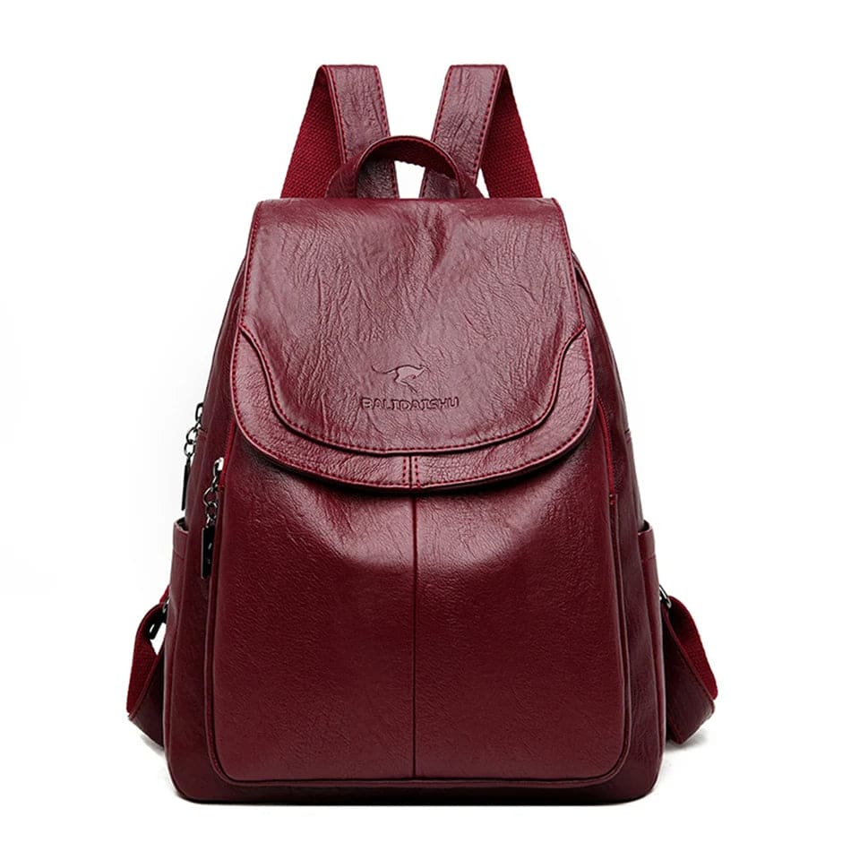 Zaino in pelle rosso bordeaux, design elegante con tasche multiple e chiusura a zip, ideale per scuola o lavoro. Accessorio moda versatile.