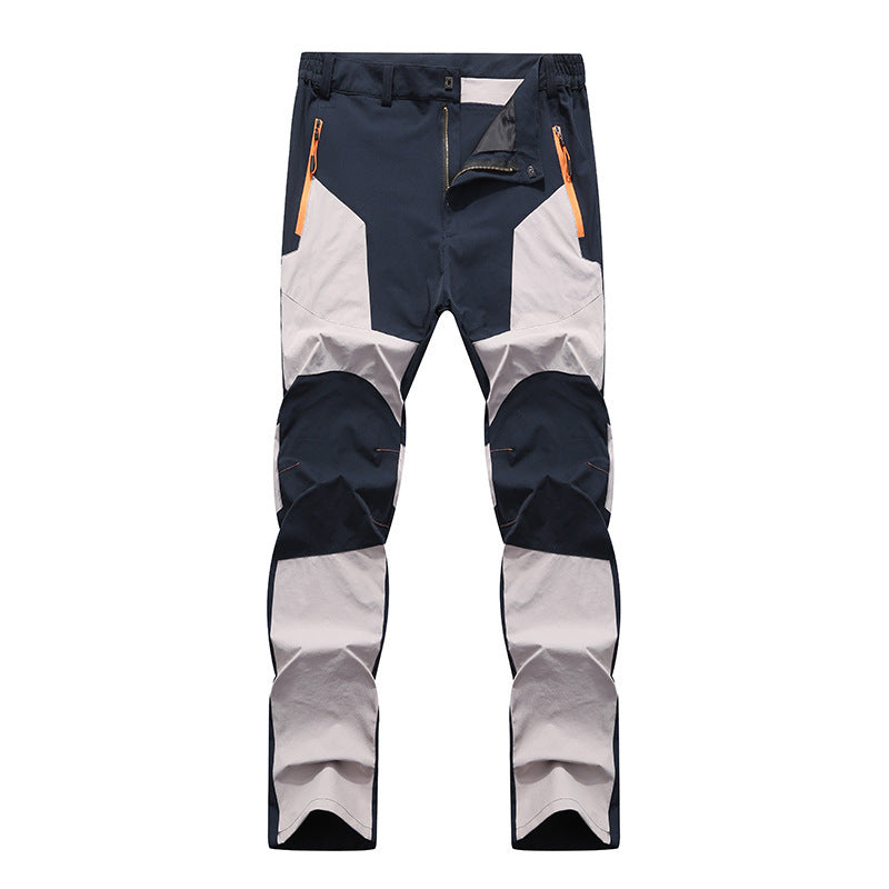 Pantaloni da trekking impermeabili, antivento, multicolore blu e grigio, con tasche con zip arancioni, ideali per escursionismo e outdoor.