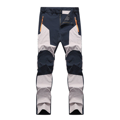 Pantaloni da trekking impermeabili, antivento, multicolore blu e grigio, con tasche con zip arancioni, ideali per escursionismo e outdoor.