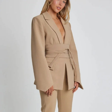 Women's autumn blazer with a belt and long bell sleeves.