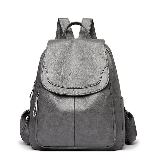 Zaino in pelle grigia elegante con tasche laterali e chiusura a zip, ideale per scuola o lavoro. Design moderno e resistente.