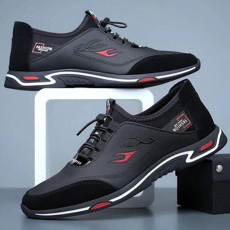 Scarpe sportive nere da uomo con dettagli rossi, suola antiscivolo e design moderno. Ideali per corsa e attività all'aperto.