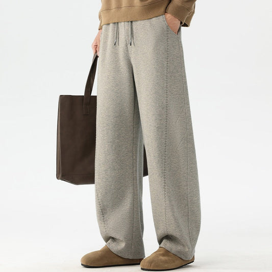 Pantalones de chándal para hombre de pierna ancha y corte holgado con cintura elástica y cordón ajustable, y bolsillos laterales.