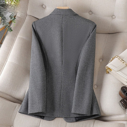 Giacca elegante grigia a quadri su divano beige, moda uomo, tessuto di alta qualità, stile classico, abbigliamento formale, accessori di lusso.