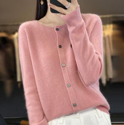 Donna con cardigan rosa in cashmere, bottoni frontali, sfondo sfocato di negozio di abbigliamento. Moda autunnale, stile elegante e casual.