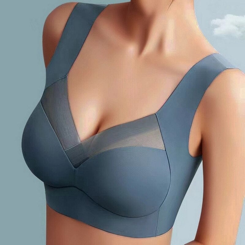 Reggiseno sportivo grigio con scollo a V e inserti in rete trasparente, design senza cuciture, supporto confortevole per attività sportive.