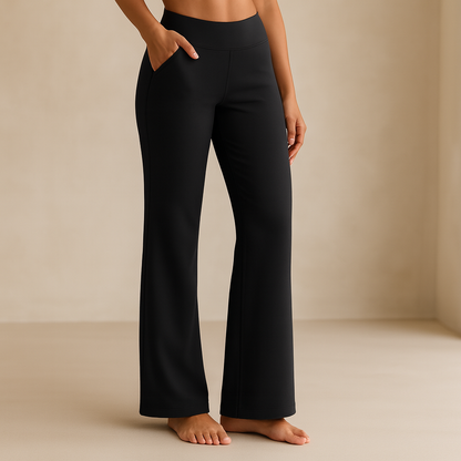 Pantaloni yoga neri a zampa, indossati da una donna a piedi nudi su sfondo neutro. Abbigliamento sportivo comodo ed elegante.