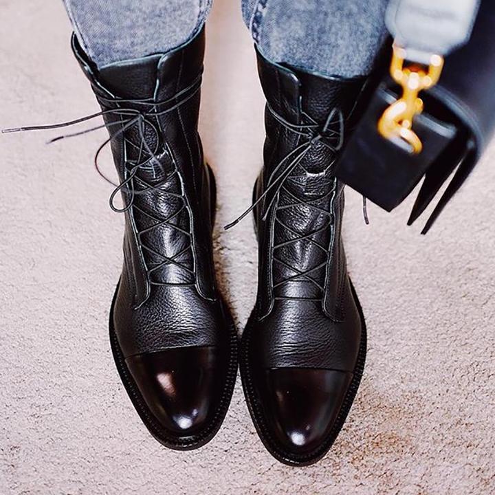 Women's mid-calf lace-up boots with a flat sole and British-inspired design.