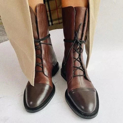 Women's mid-calf lace-up boots with a flat sole and British-inspired design.