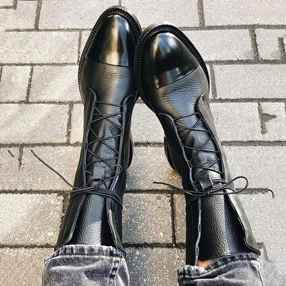 Women's mid-calf lace-up boots with a flat sole and British-inspired design.