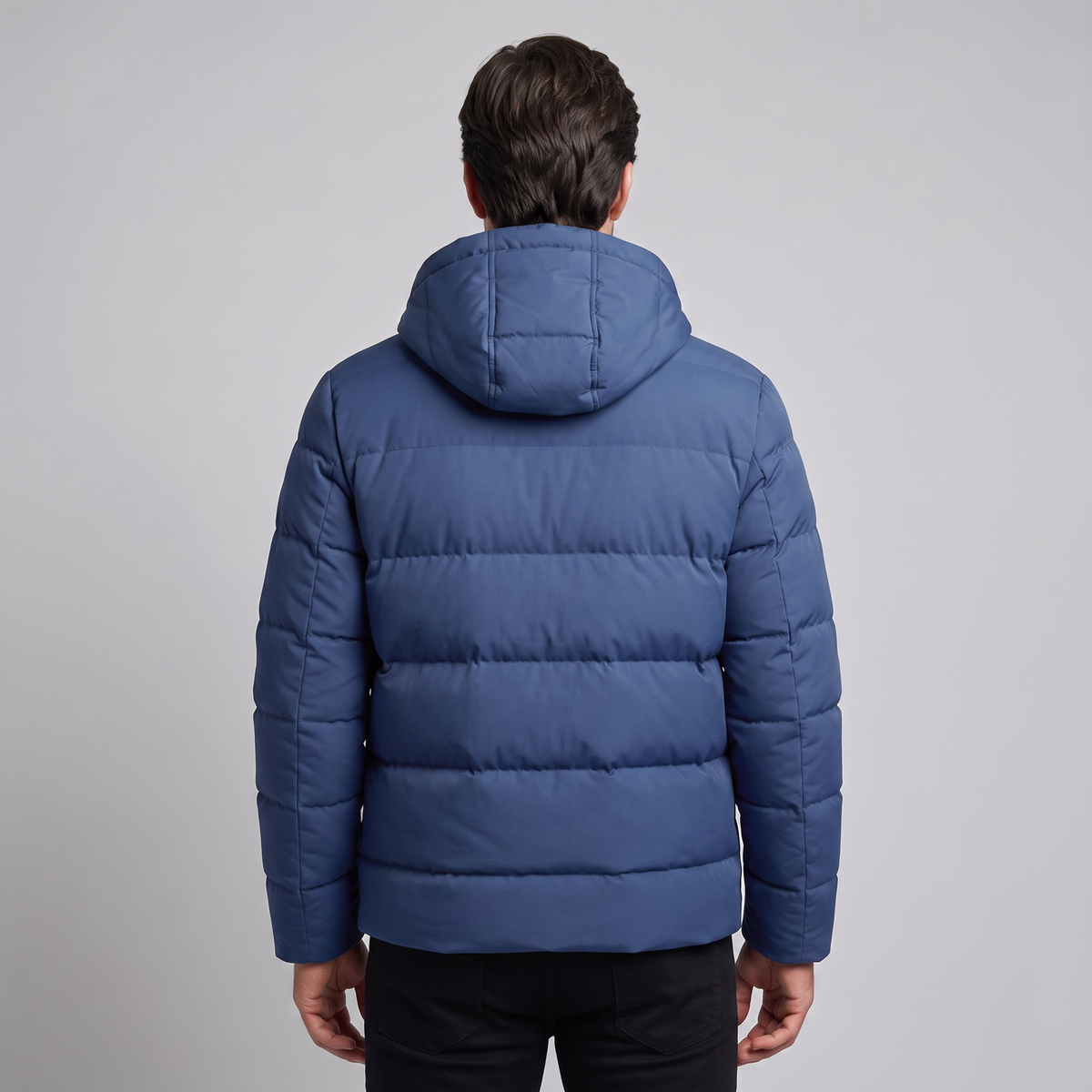 Men's winter jacket with a hood, quilted padding, and polyester insulation.