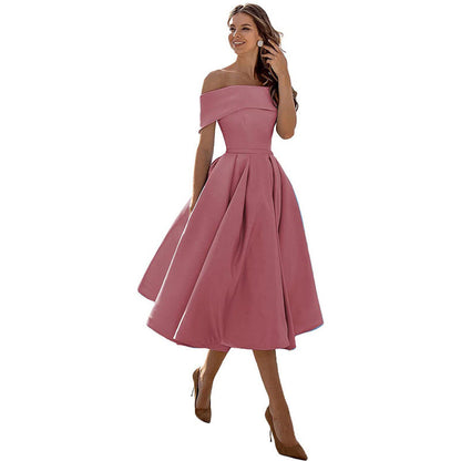 Abito rosa elegante da donna, stile off-shoulder, lunghezza midi, perfetto per cerimonie e occasioni speciali. Moda femminile sofisticata.
