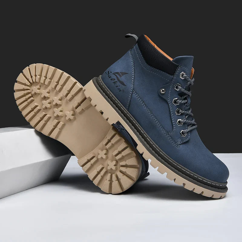 Scarponcini da trekking blu con suola in gomma beige, design robusto, lacci resistenti, ideali per escursioni e attività outdoor.