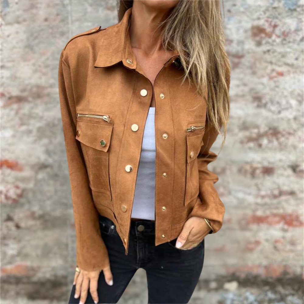 Giacca marrone scamosciata da donna con bottoni dorati, indossata sopra una maglietta bianca e jeans neri. Moda autunnale casual elegante.