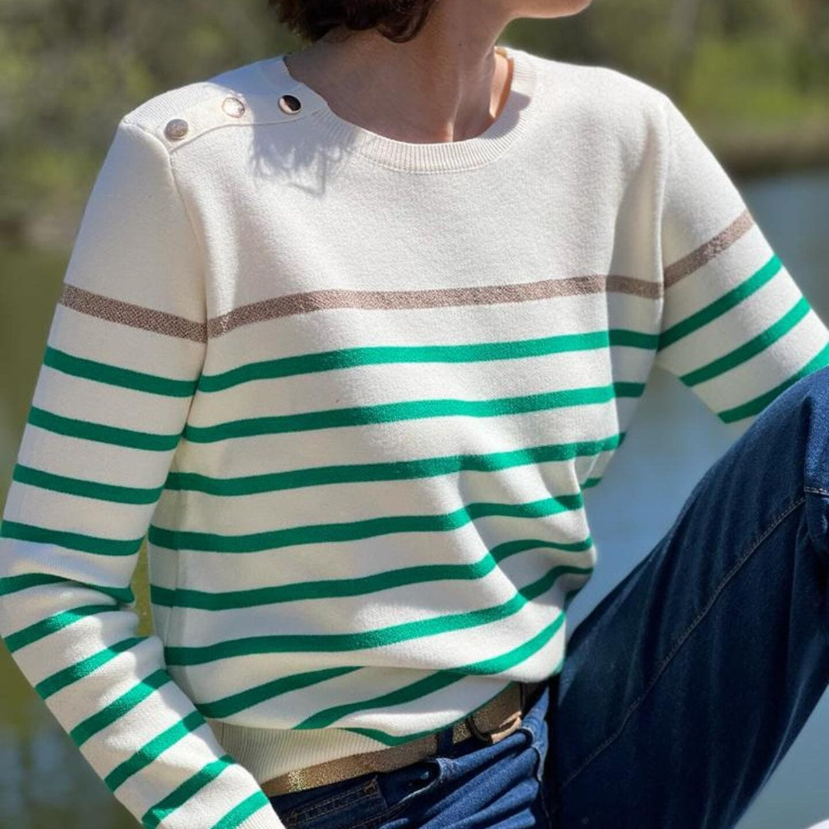 Women's striped knit sweater with a crew neck and shoulder buttons