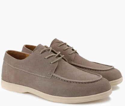 Men’s suede-style boat shoes with laces, moccasin stitching, and a thick contrasting sole.