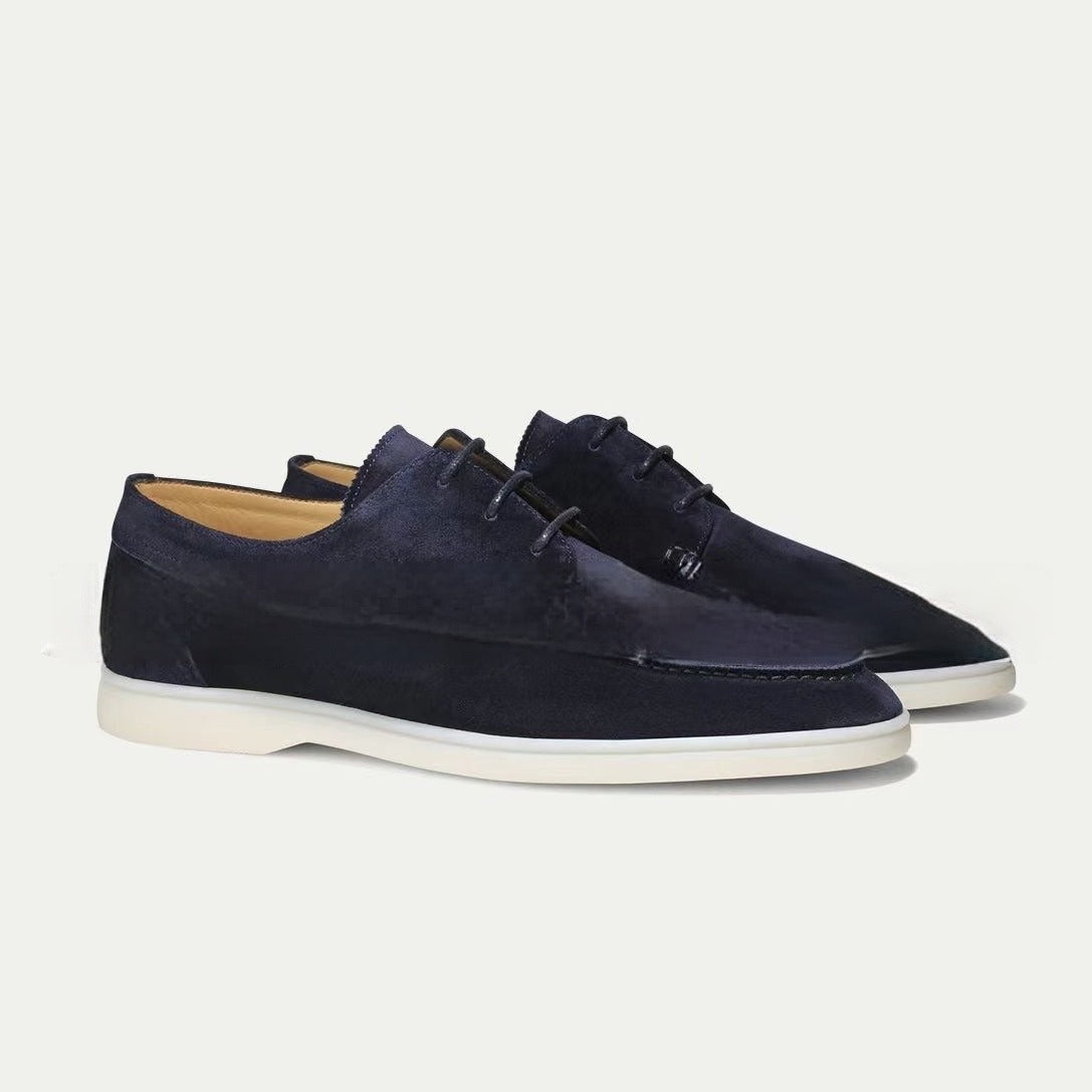 Men’s suede-style boat shoes with laces, moccasin stitching, and a thick contrasting sole.