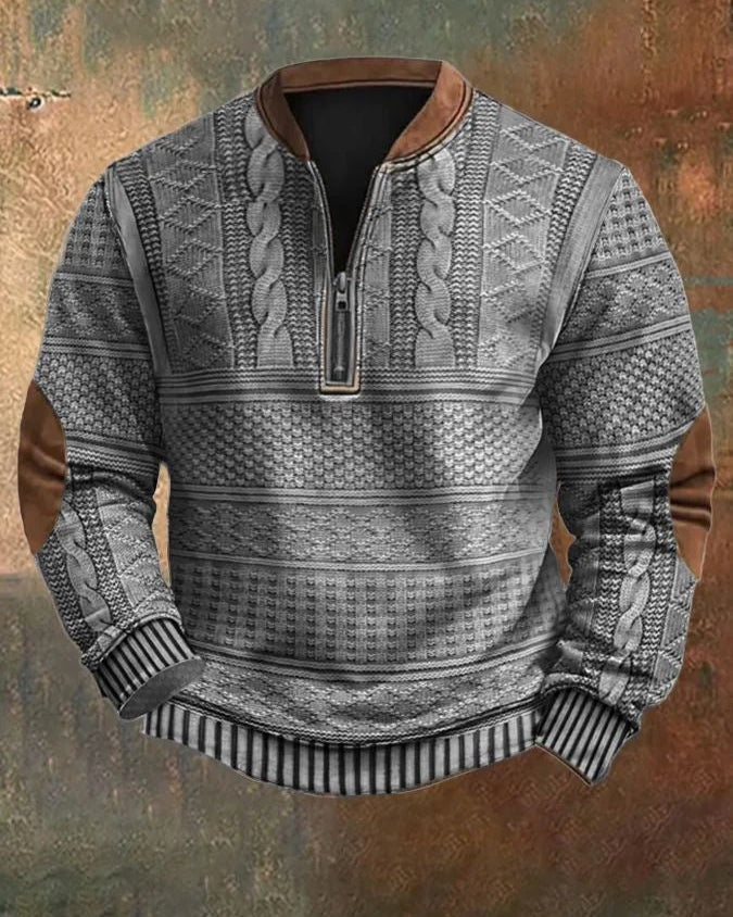 Maglione invernale grigio con motivo a trecce, cerniera frontale, dettagli in pelle marrone sui gomiti, ideale per moda uomo autunno-inverno.