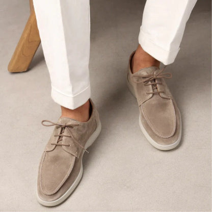 Men’s suede-style boat shoes with laces, moccasin stitching, and a thick contrasting sole.
