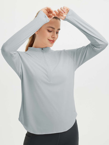 Damebluse med lange ærmer, afrundet kant, tommelhuller