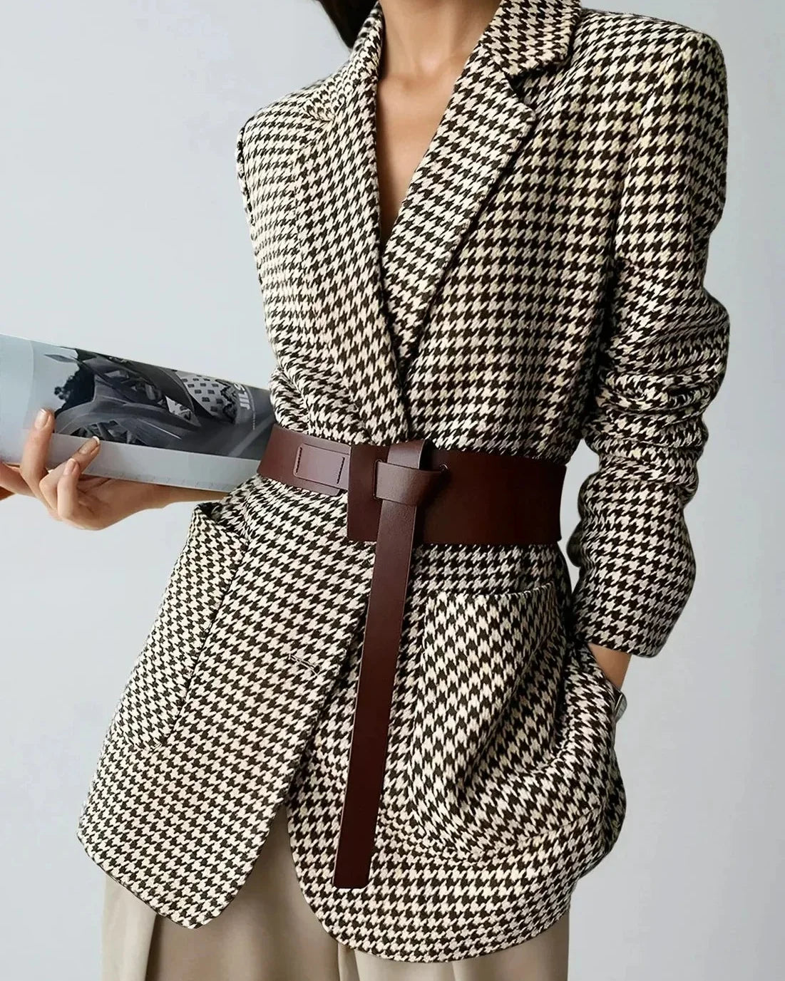 Women's fall blazer with a houndstooth print, adjustable belt, and slit