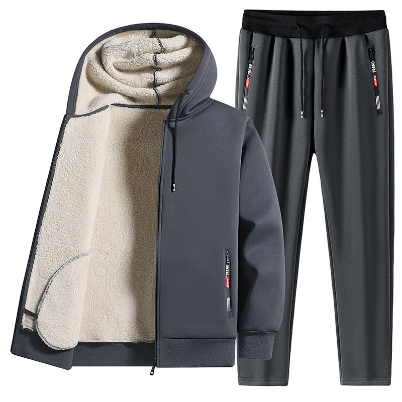 Tuta sportiva invernale grigia con cappuccio, interno in pile, pantaloni con coulisse. Abbigliamento caldo e comodo per attività all'aperto.
