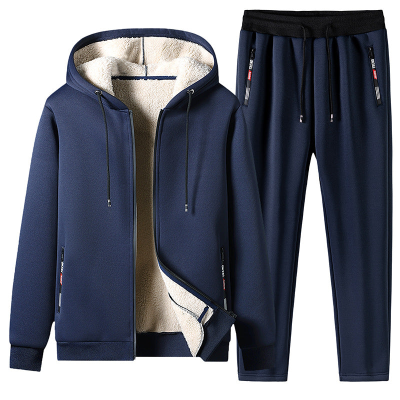 Tuta sportiva invernale blu scuro con cappuccio e fodera in pile, pantaloni con coulisse, ideale per attività all'aperto e tempo libero.