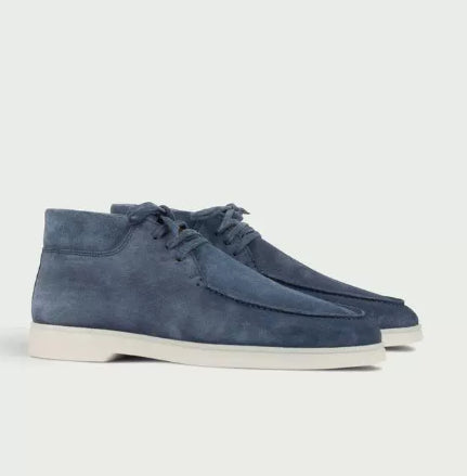 Men’s suede-style boat shoes with laces, moccasin stitching, and a thick contrasting sole.