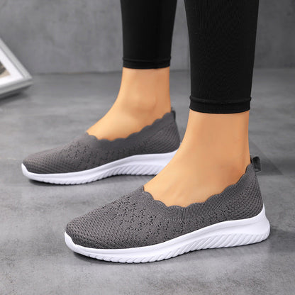 Scarpe da ginnastica grigie da donna, design senza lacci, suola bianca antiscivolo, tessuto traspirante, ideali per camminata e sport casual.