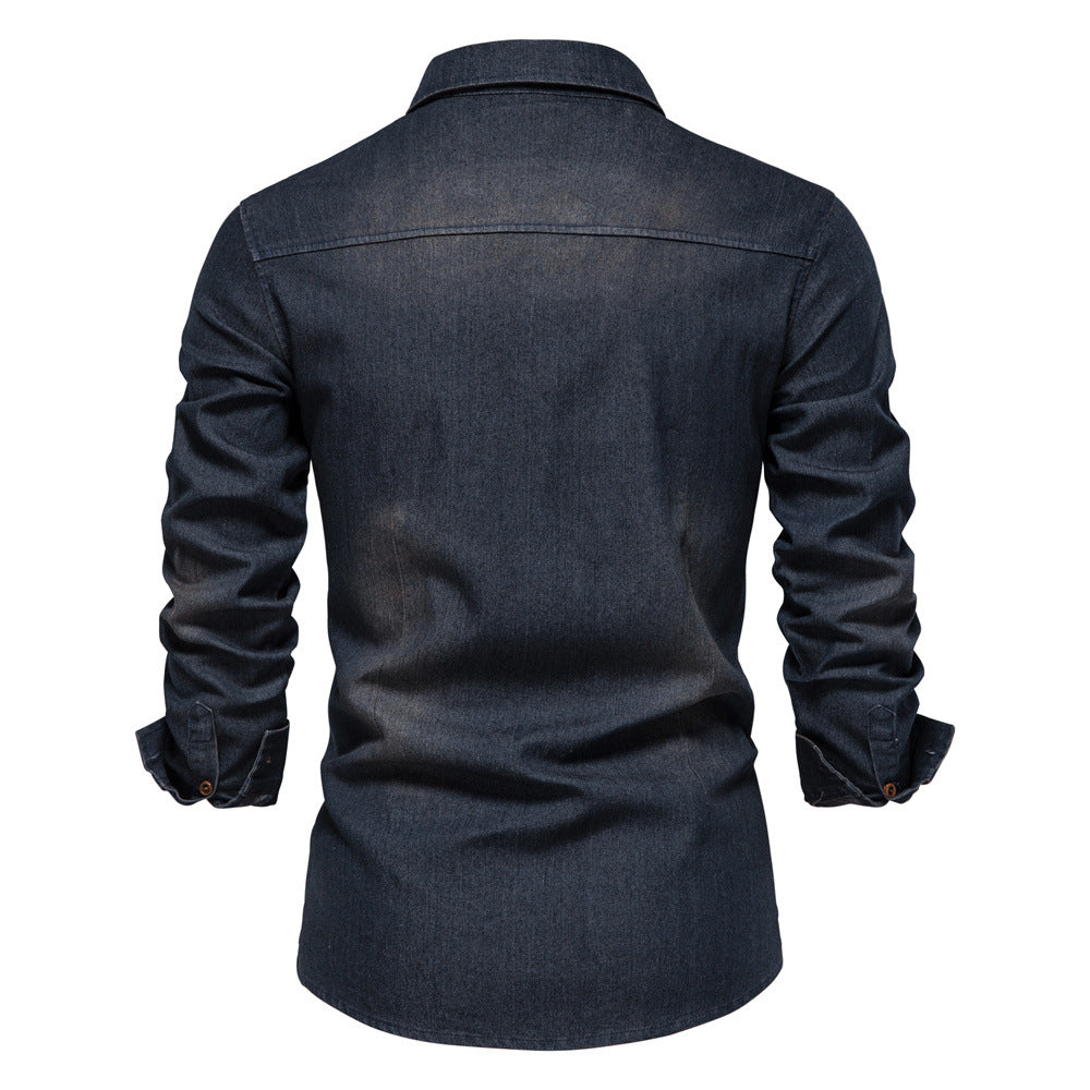 Men's solid-color denim shirt with textured fabric, chest pockets, and long sleeves.