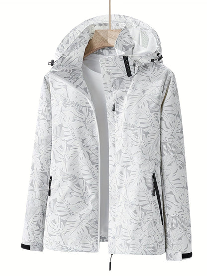 Giacca a vento bianca con cappuccio, motivo foglie tropicali, chiusura zip, tasche laterali, ideale per outdoor e sport. Moda donna autunno.