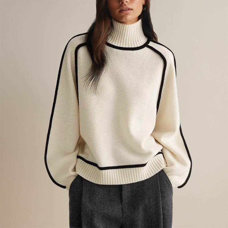 Maglione bianco a collo alto con bordi neri, indossato da una donna. Moda autunnale elegante, abbigliamento casual chic, tendenze moda 2023.