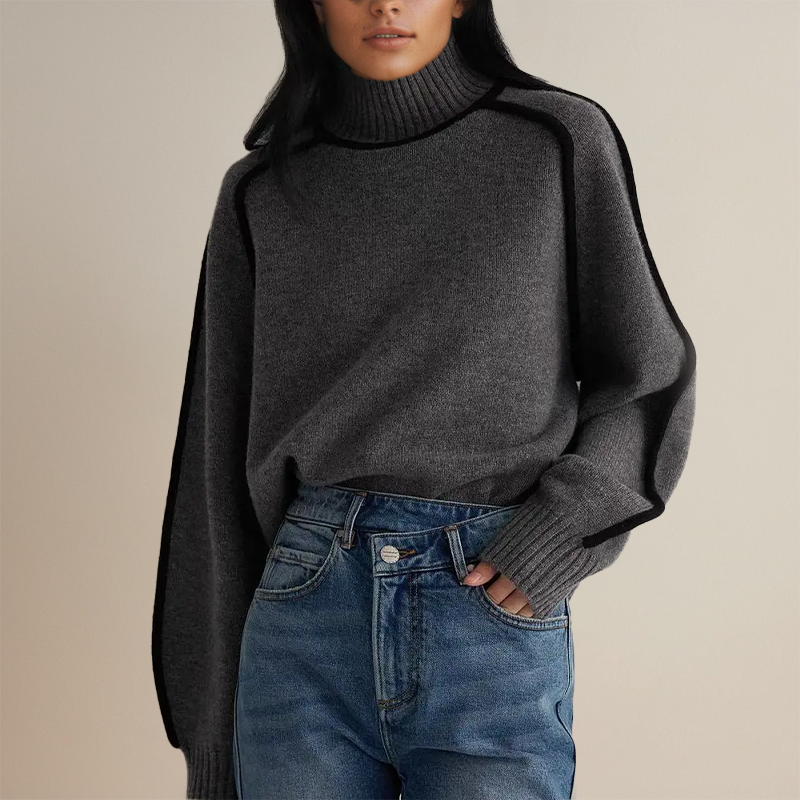 Donna con maglione grigio a collo alto e jeans blu. Moda autunnale, abbigliamento casual elegante, stile minimalista.