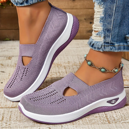 Scarpe da ginnastica viola da donna, traspiranti e leggere, con suola bianca e dettagli traforati, abbinate a jeans strappati e cavigliera con perline turchesi.