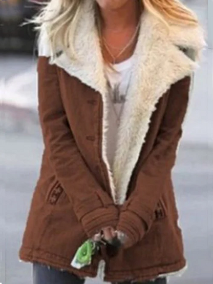 Donna con cappotto marrone invernale con collo in pelliccia bianca, tiene chiavi in mano. Moda autunnale, abbigliamento caldo, stile casual.