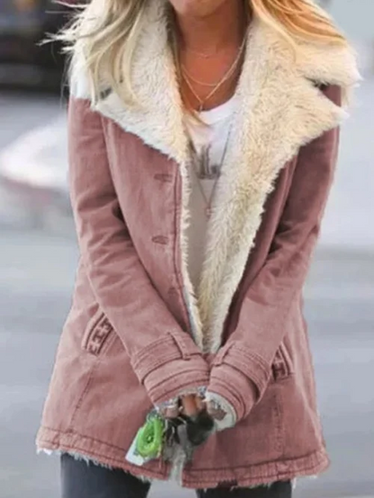Donna con cappotto invernale rosa con fodera in pelliccia sintetica bianca, strada urbana. Moda femminile, abbigliamento caldo, stile casual.