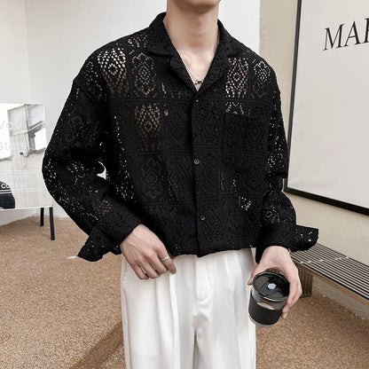 Uomo con camicia nera traforata in pizzo, pantaloni bianchi, tiene una tazza di caffè. Moda maschile elegante, stile casual chic.