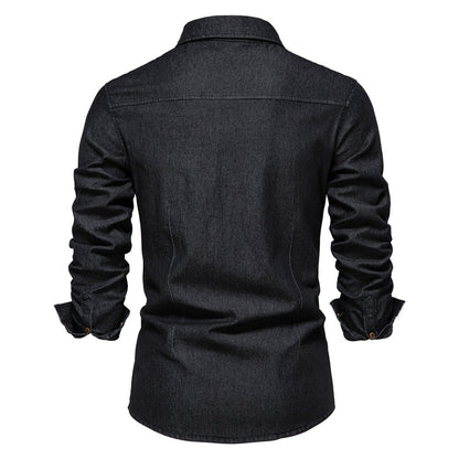 Men's solid-color denim shirt with textured fabric, chest pockets, and long sleeves.