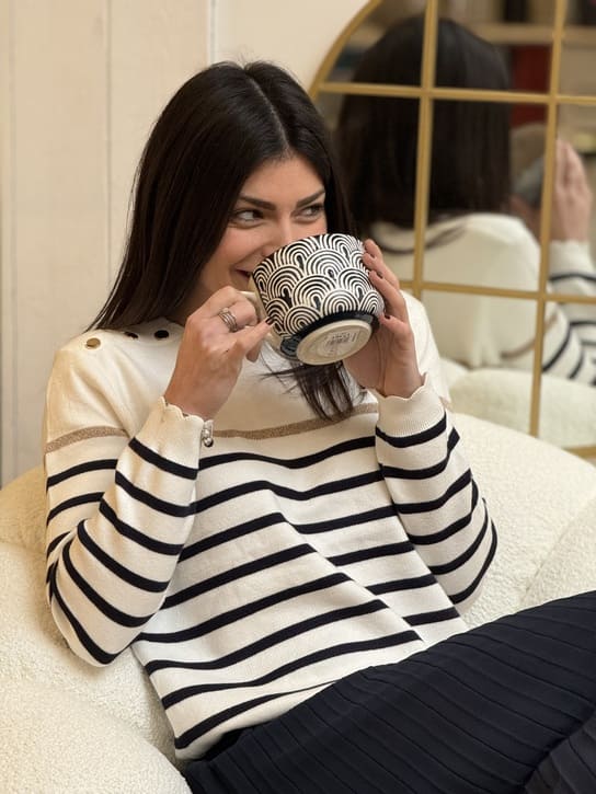 Women's striped knit sweater with a crew neck and shoulder buttons