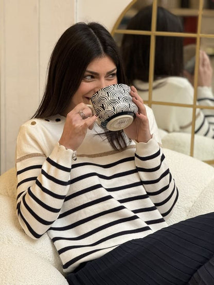 Women's striped knit sweater with a crew neck and shoulder buttons